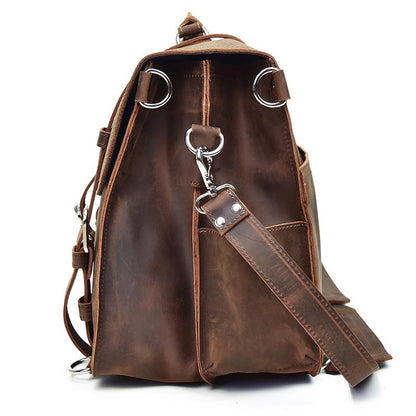 Brown leather backpack with shoulder strap on a white background