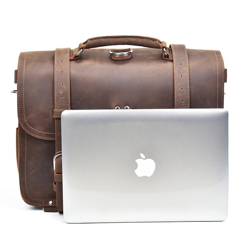 Brown leather briefcase with a silver laptop on a white background
