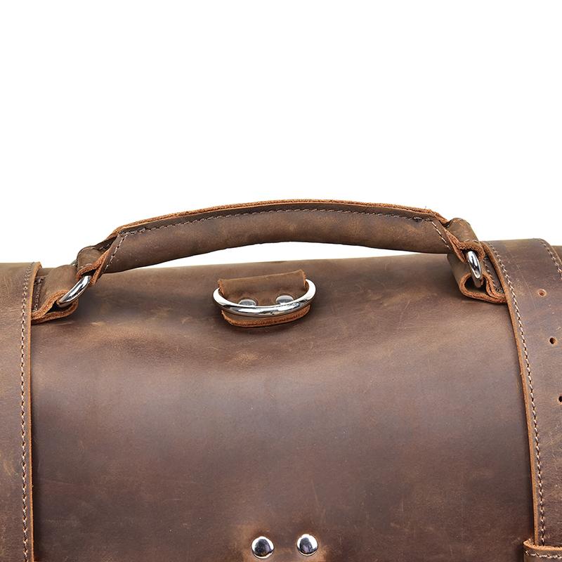 Close-up of a brown leather bag with visible stitching on a white background