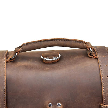 Close-up of a brown leather bag with visible stitching on a white background