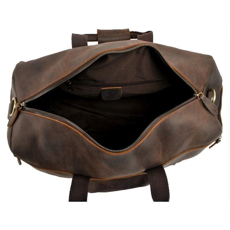 Brown leather duffel bag with open top on a white background