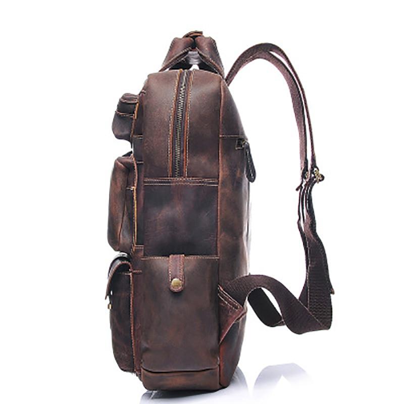 Brown leather backpack, side view on a white background