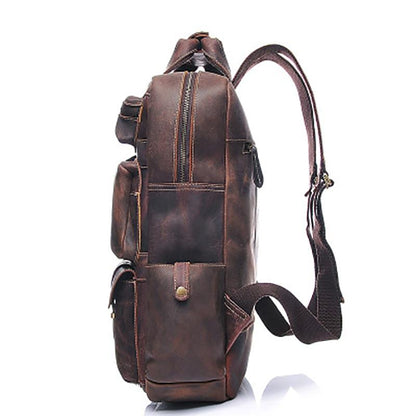Brown leather backpack, side view on a white background