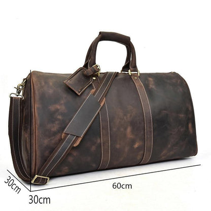 Brown leather duffel bag with measurements on a white background