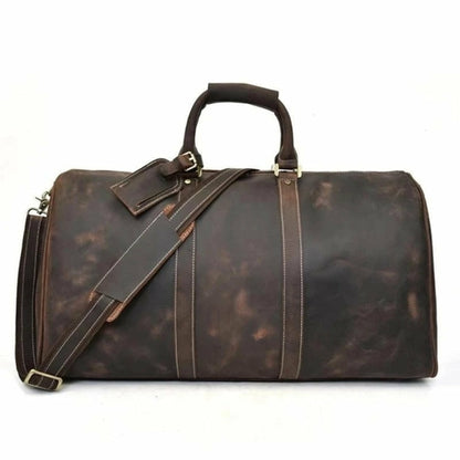 Brown leather duffel bag with shoulder strap on a white background