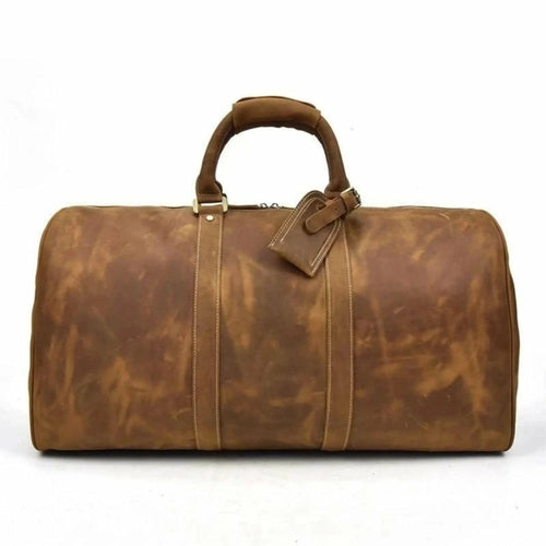 Brown leather duffel bag on a white background