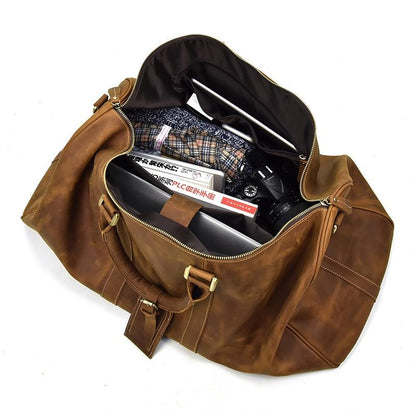 Brown leather duffel bag with items inside on a white background