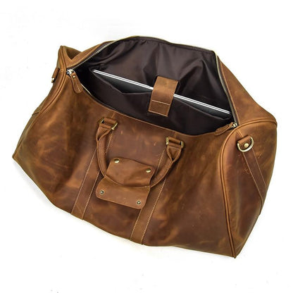 Brown leather duffel bag with a laptop compartment on a white background