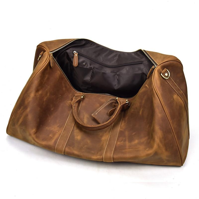 Brown leather handbag with gold hardware on a white background