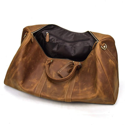 Brown leather handbag with gold hardware on a white background