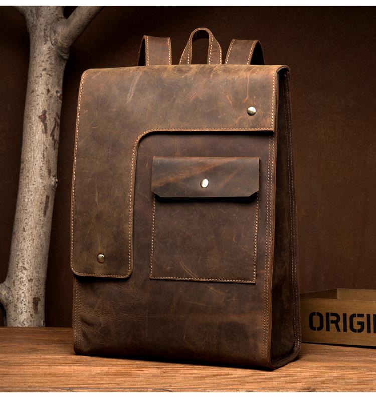Brown leather backpack on a wooden surface with a brown background