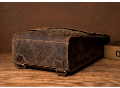 Brown leather bag on a wooden surface with a brown background
