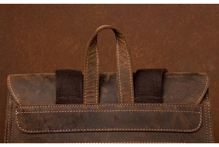 Brown leather bag with handles on a brown background