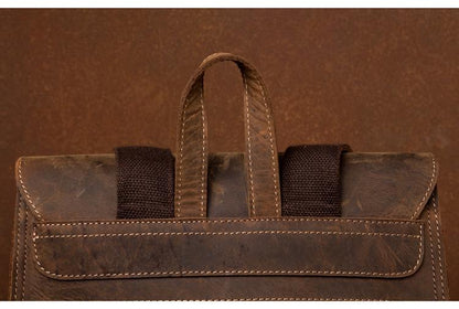 Brown leather bag with handles on a brown background