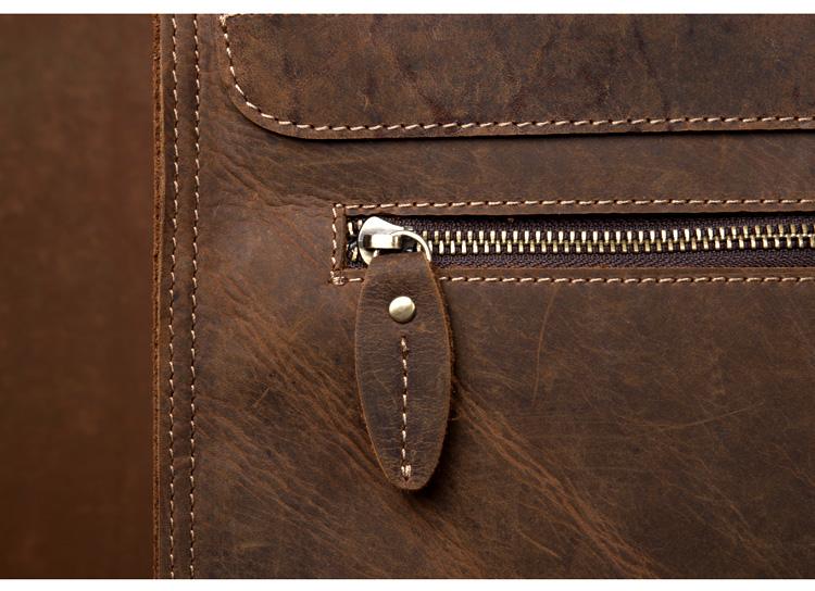 Close-up of a brown leather bag with a zipper