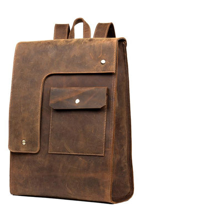 Brown leather backpack with a front pocket on a white background