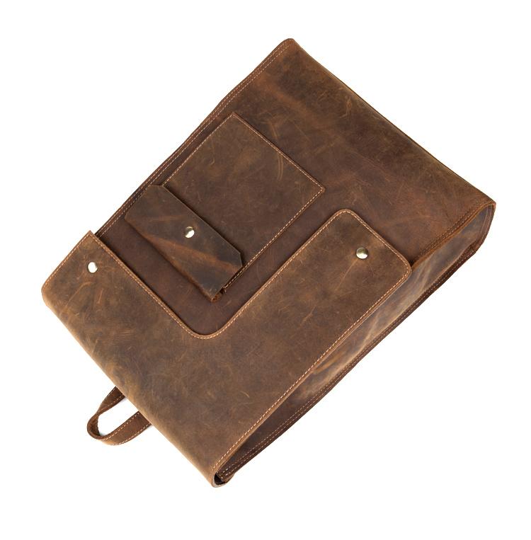 Brown leather bag with multiple pockets on a white background
