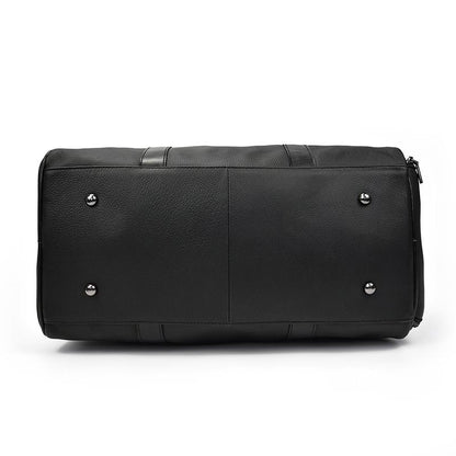 Black leather duffel bag with silver studs on a white background