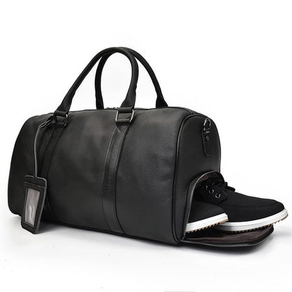 Black leather duffel bag with a shoe compartment on a white background