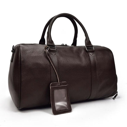 Brown leather duffel bag with a clear tag on a white background