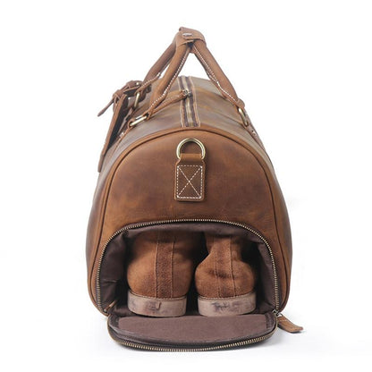 Brown leather duffel bag with a pair of brown shoes inside on a white background
