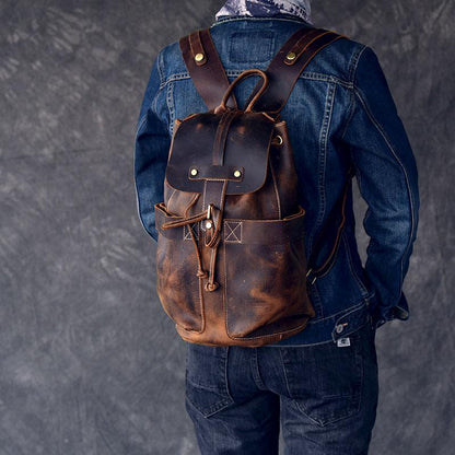 Person wearing a brown leather backpack with a gray background