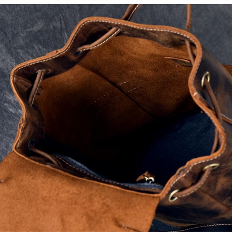 Brown leather bag with visible stitching on a textured blue background