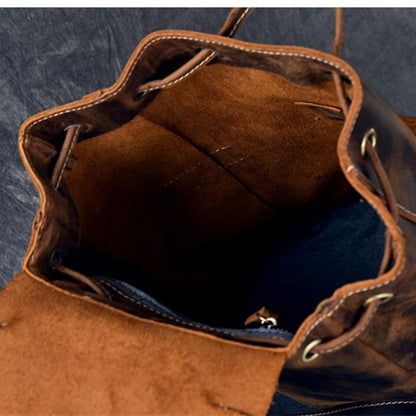 Brown leather bag with visible stitching on a textured blue background