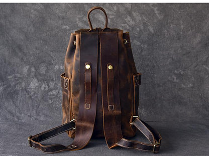 Brown leather backpack on a dark gray background