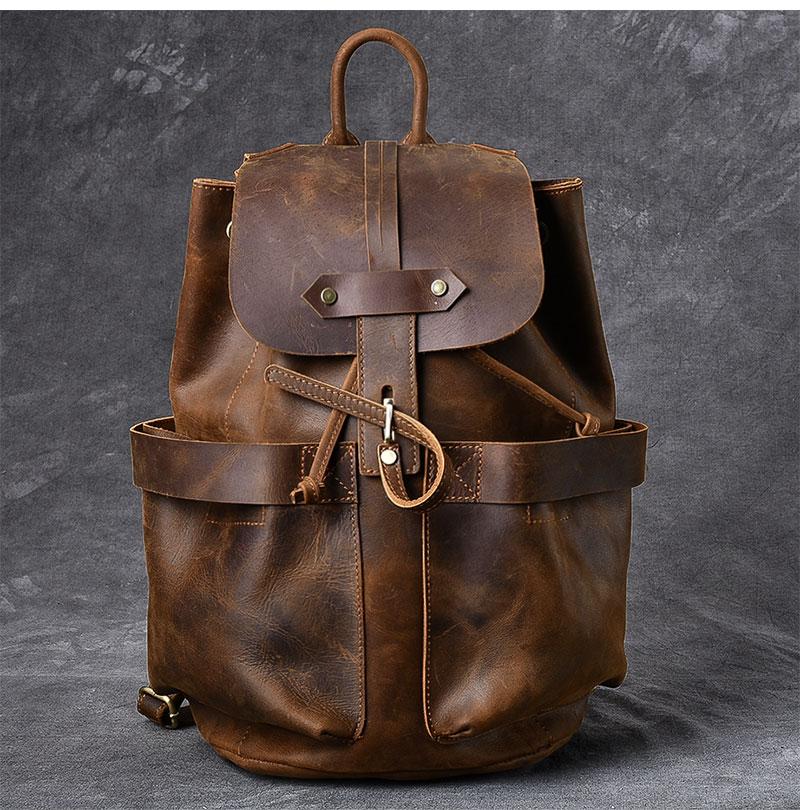 Brown leather backpack on a gray background