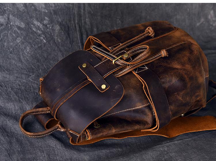 Brown leather bag with gold accents on a dark gray background