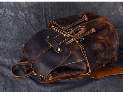 Brown leather bag with gold accents on a dark gray background
