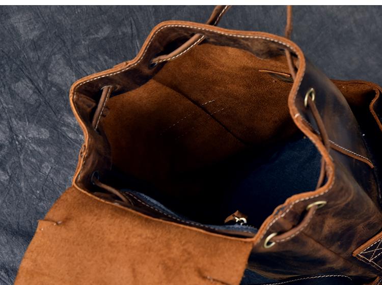 Brown leather bag with a textured interior on a dark blue background