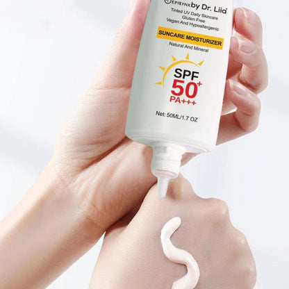 Hand applying Dr. Liia sunscreen cream from a bottle labeled SPF 50+ PA+++ on a light background